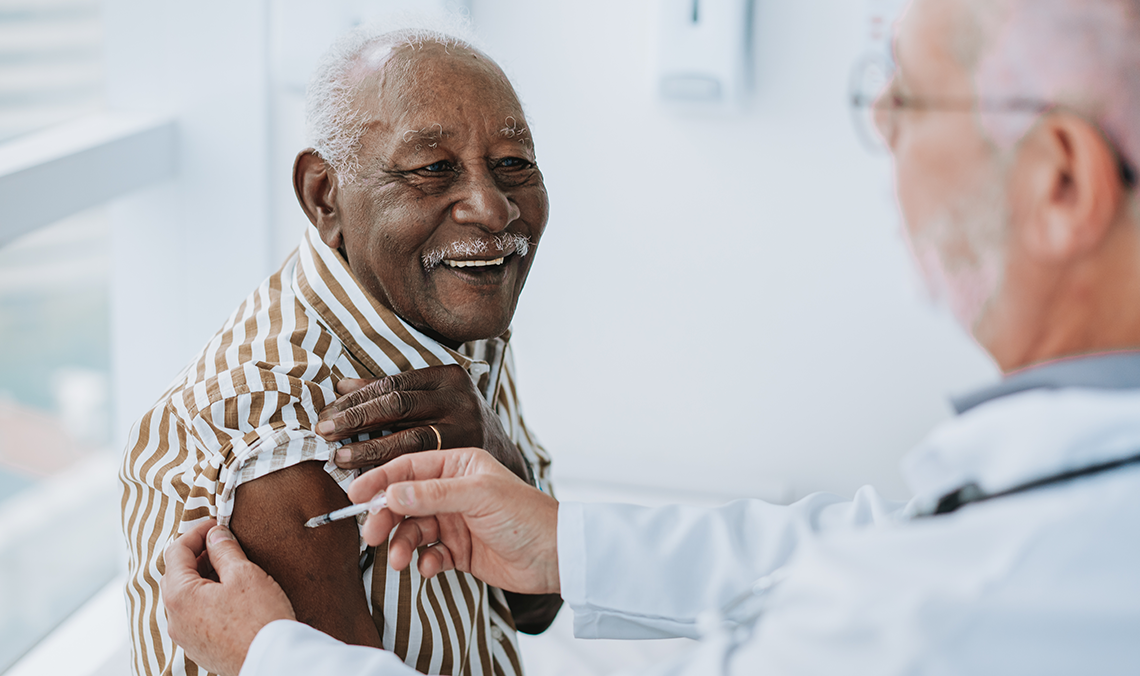 A healthcare professional vaccinates an elderly person against influenza.