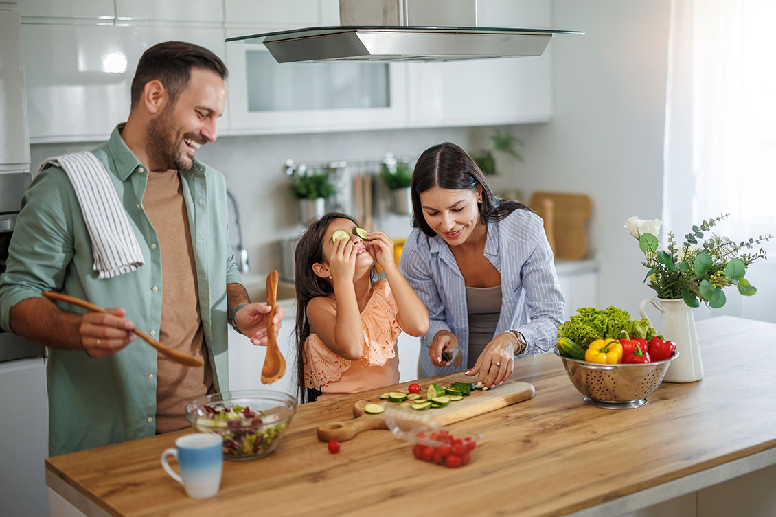 A family cooks together fresh foods full of vitamins and minerals.